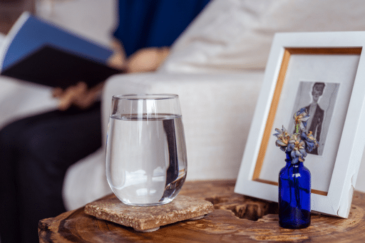 Glass of water on side table.